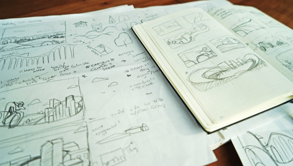 A photo of a sketchbook and several sheets of paper with notes and drawings